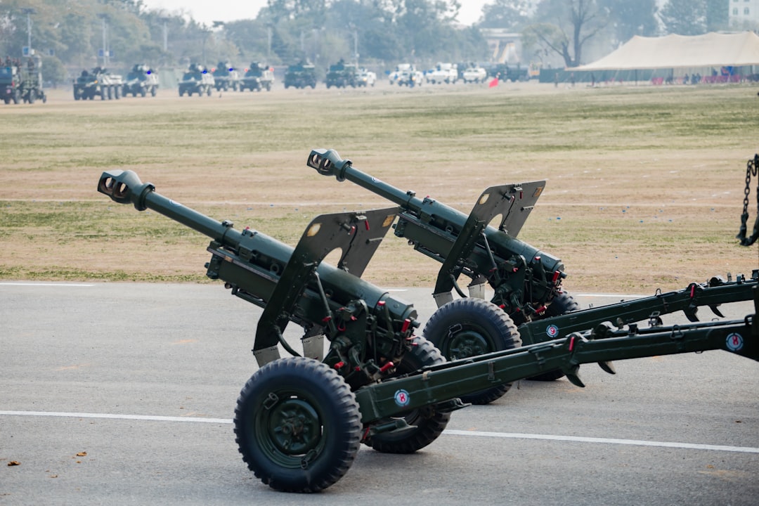 Two artillery cannons on a paved surface